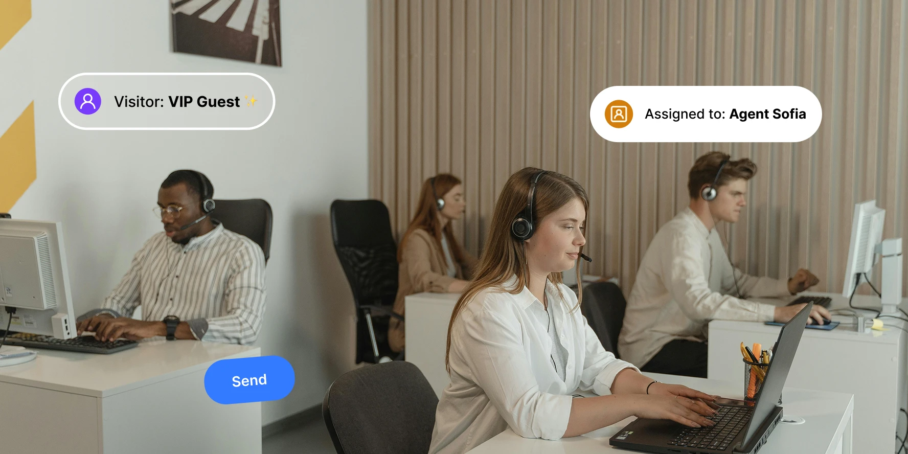 Call center agents wearing headsets working on computers in an office workspace.