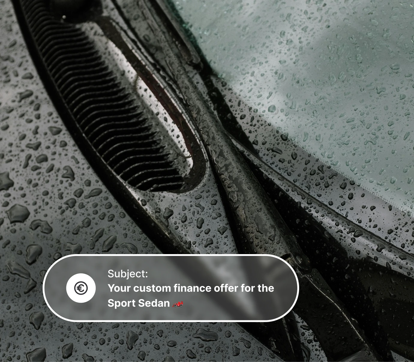 Close-up of raindrops on a car windshield and wiper with a finance offer message overlay.