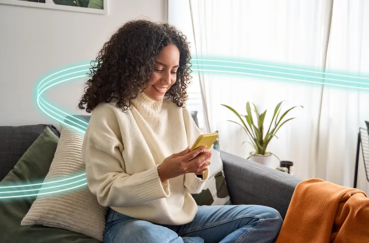 Female teen, smiling at her phone. 