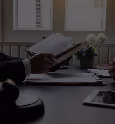 faded image of a person meeting with their legal team