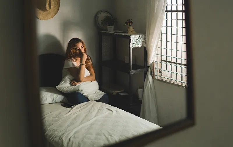 person looking out the window representing a domestic concern