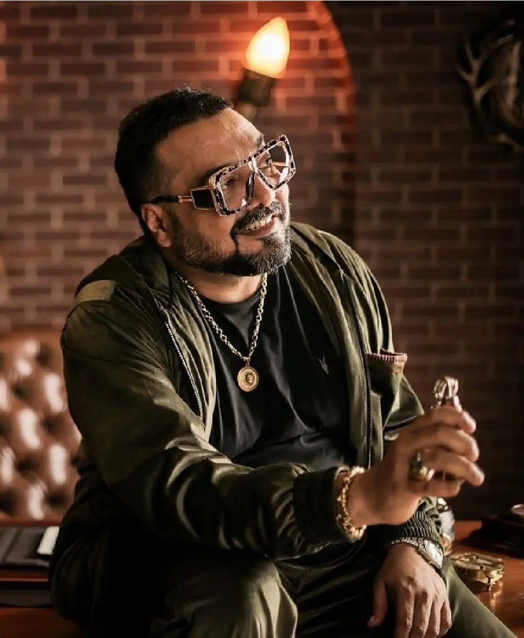 A close-up portrait of Anurag Kashyap looking intense on a dimly lit indoor film set for Saali Mohabbat.