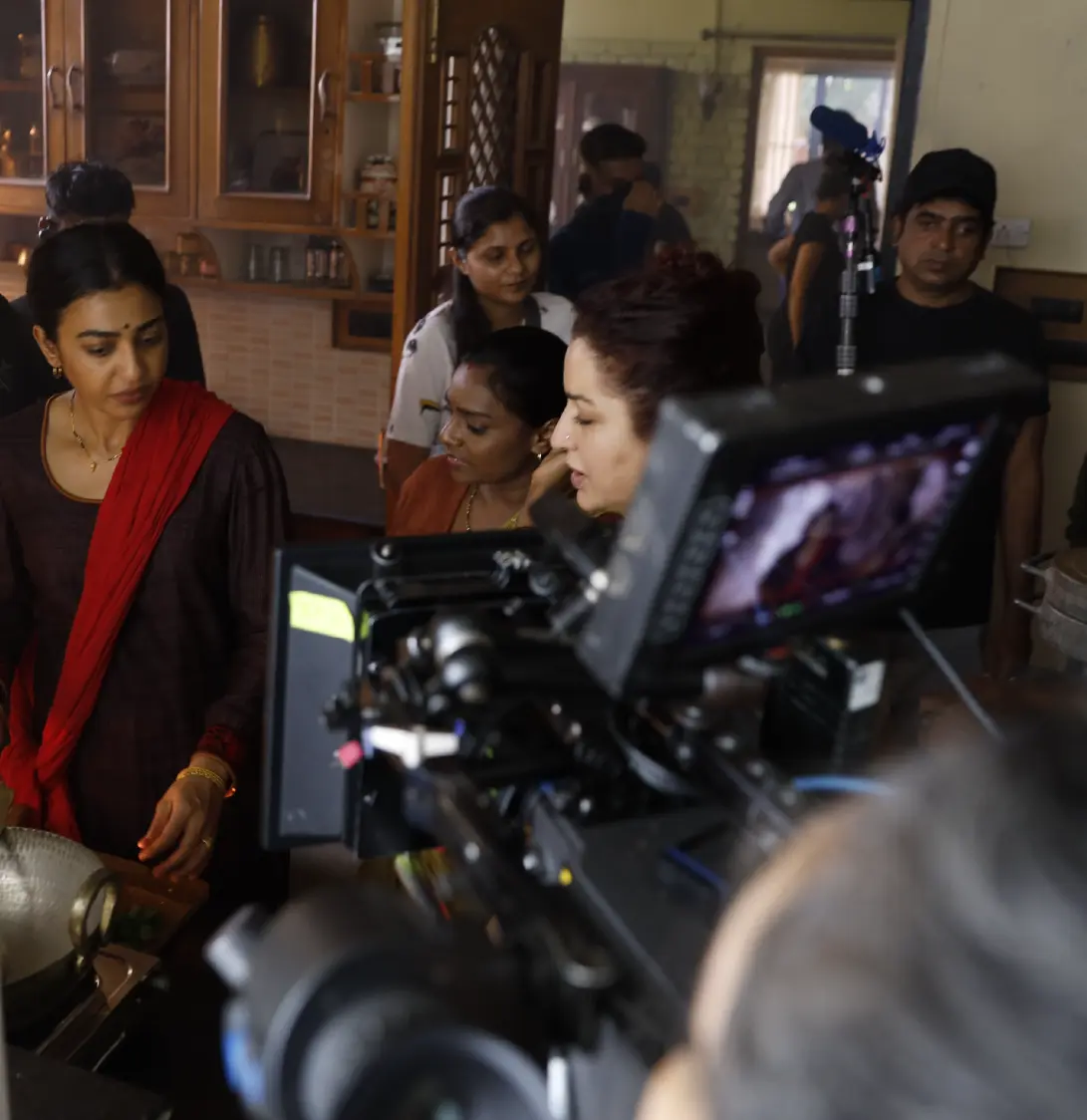 Director Tisca Chopra and Radhika Apte on the kitchen set of Saali Mohabbat; a behind-the-scenes look at the film crew and camera equipment in action.