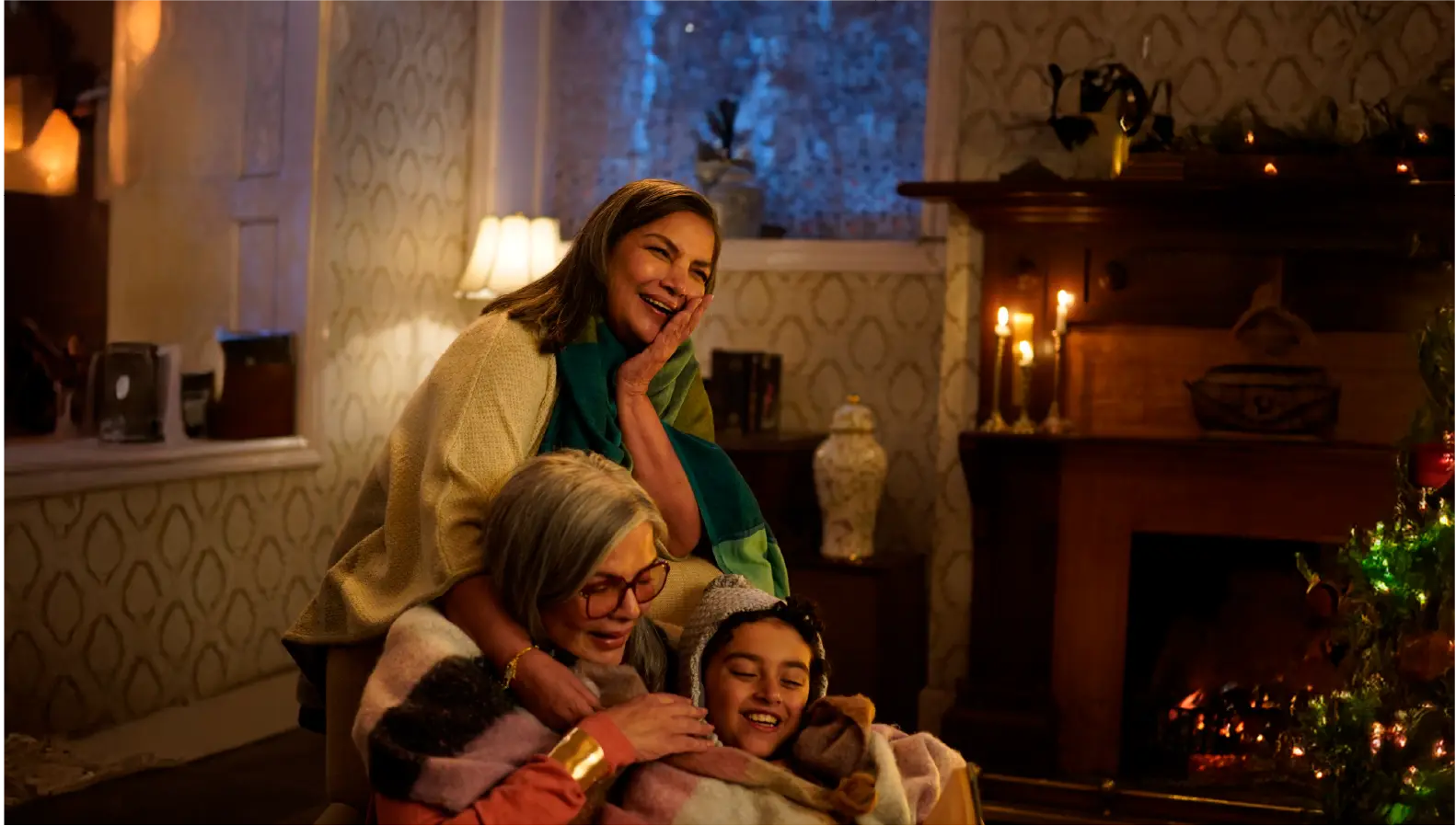 Zeenat Aman, Shabana Azmi, and Rohaan Singh sharing a laugh on the cozy, fireplace-lit set of Bun Tikki.