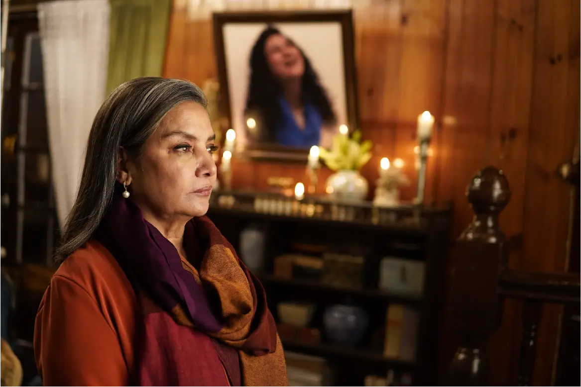Shabana Azmi on the indoor film set of Bun Tikki, positioned in front of a memorial portrait.