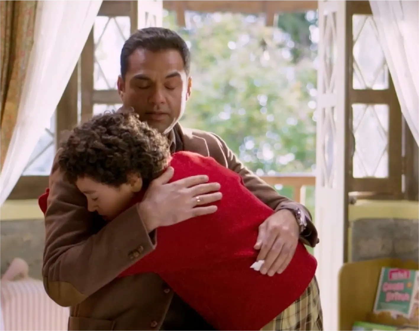 A poignant still from Bun Tikki featuring Sidhant cradling his son, Shanu.