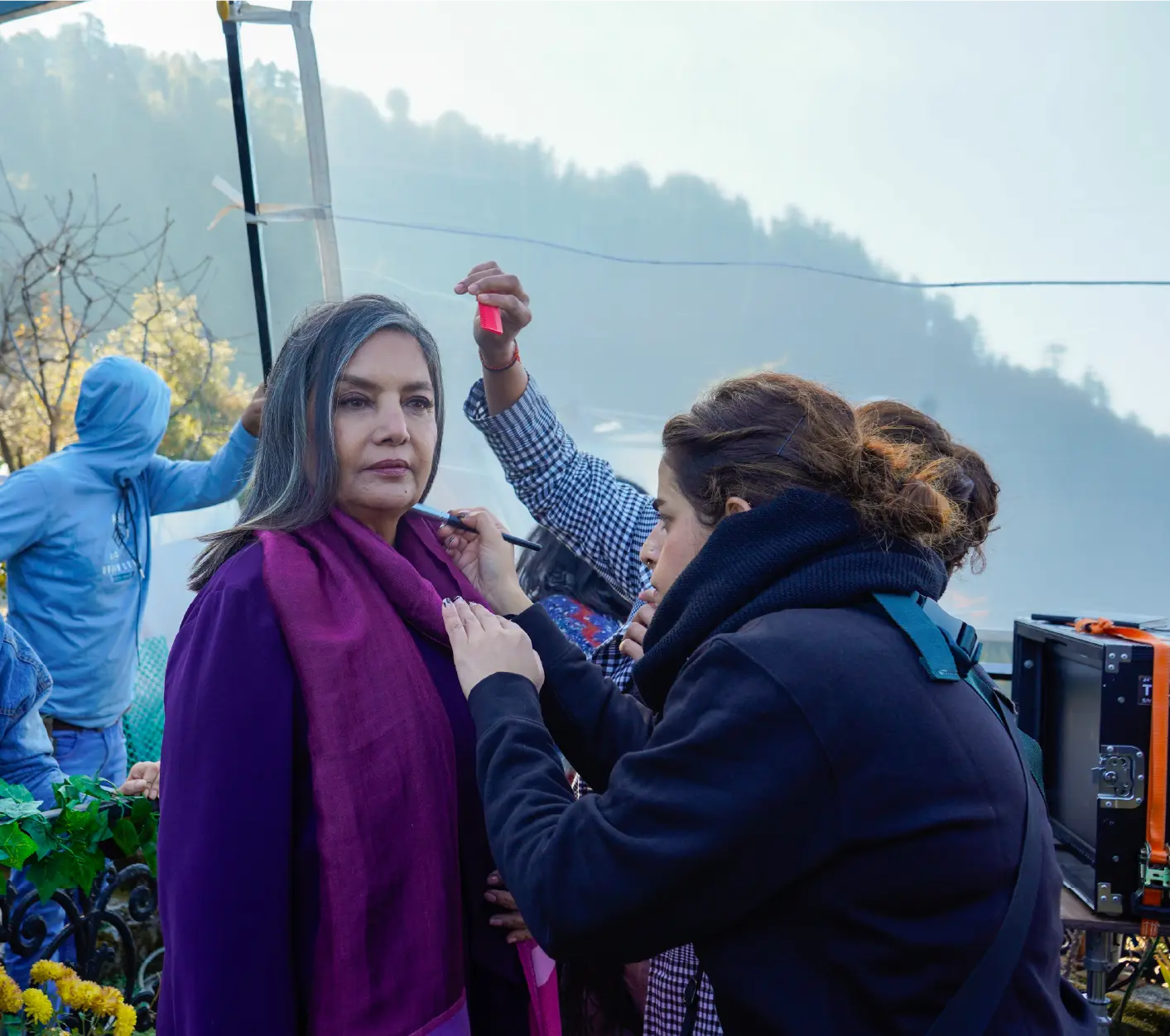 Behind-the-scenes production still of Shabana Azmi in a purple outfit during a hair and makeup session on the Bun Tikki film set.