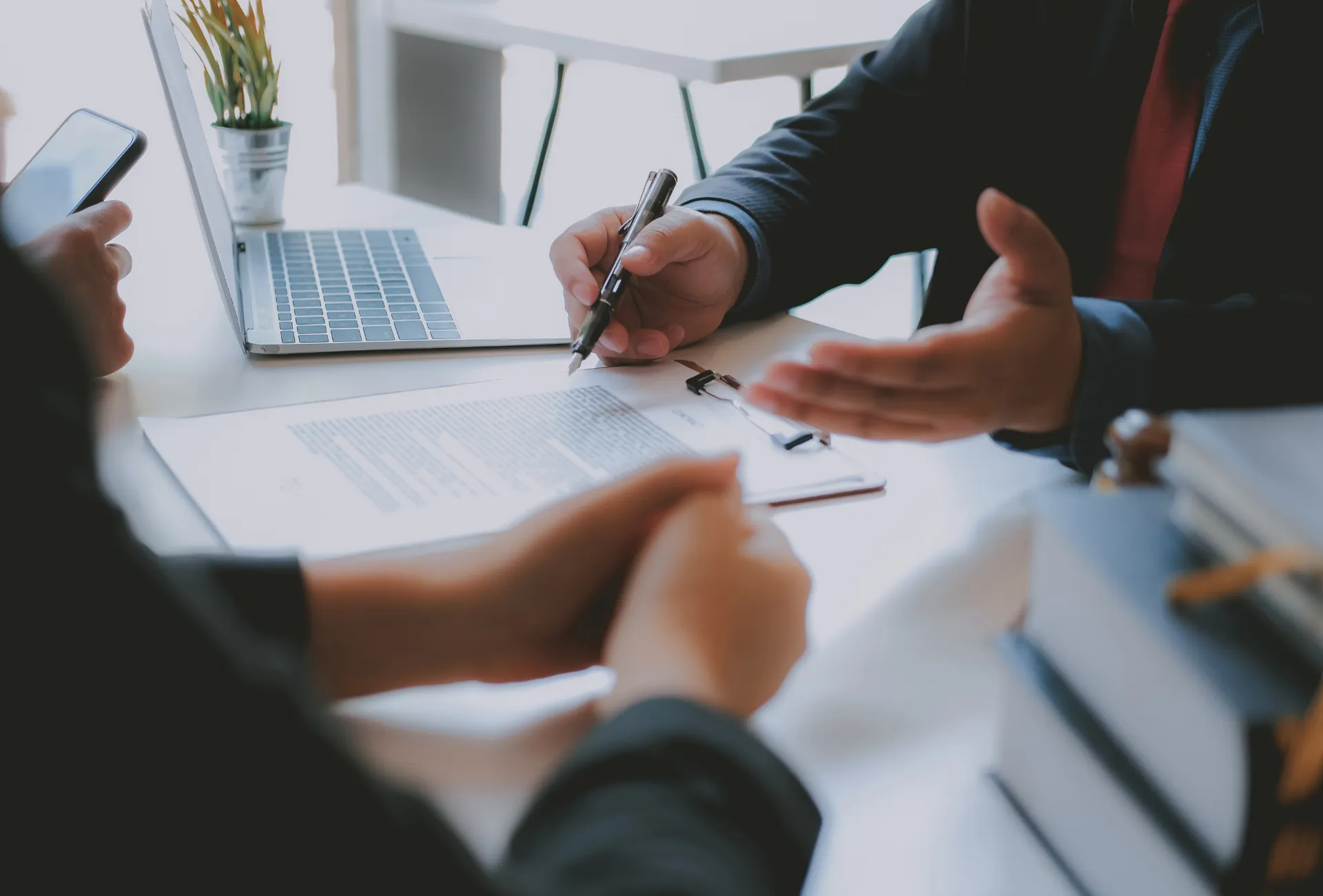 Two professionals discussing a document at a work meeting.