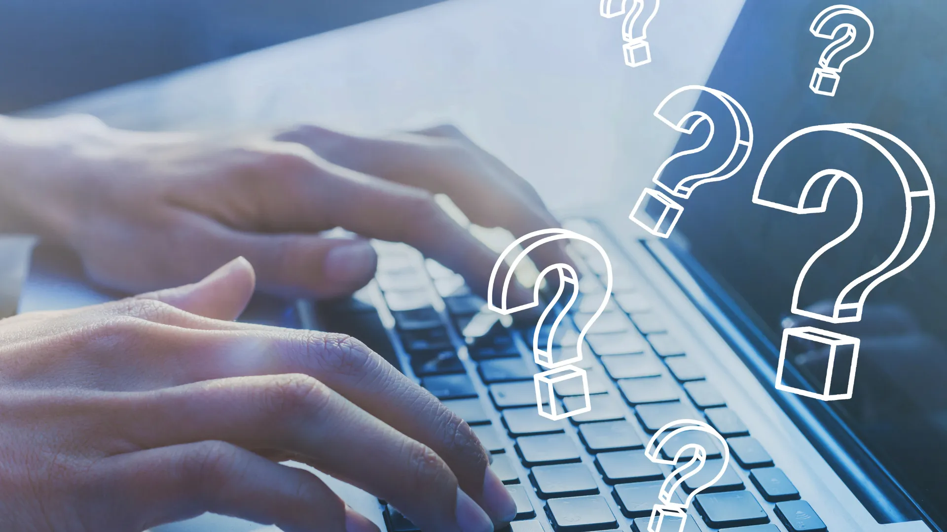 A person typing on a laptop with question marks on it.