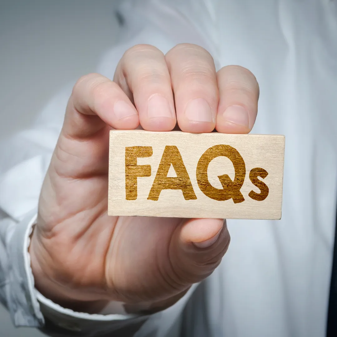 A man is pointing at a tablet with question marks on it.