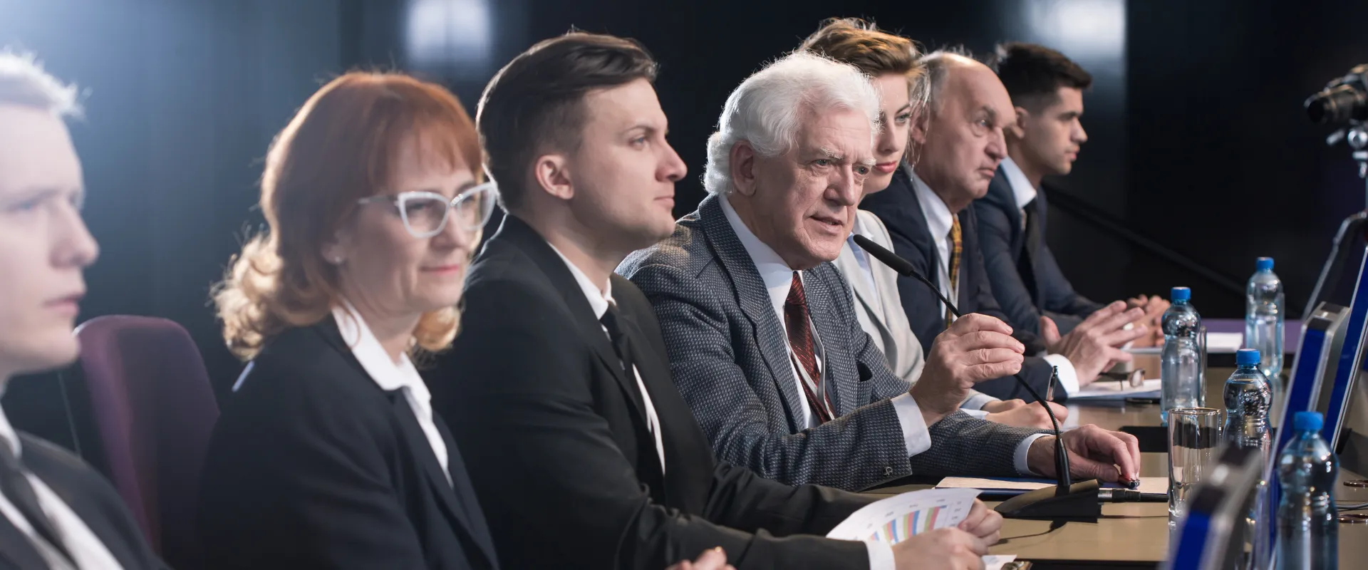 A group of business people sitting at a conference table.