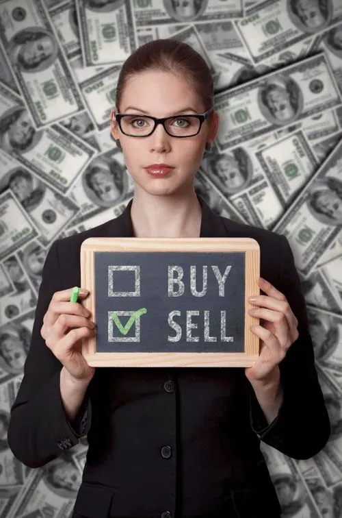 A woman holding a chalkboard with a check box and a green pen.