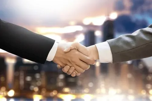 Two businessmen shaking hands in front of a cityscape.