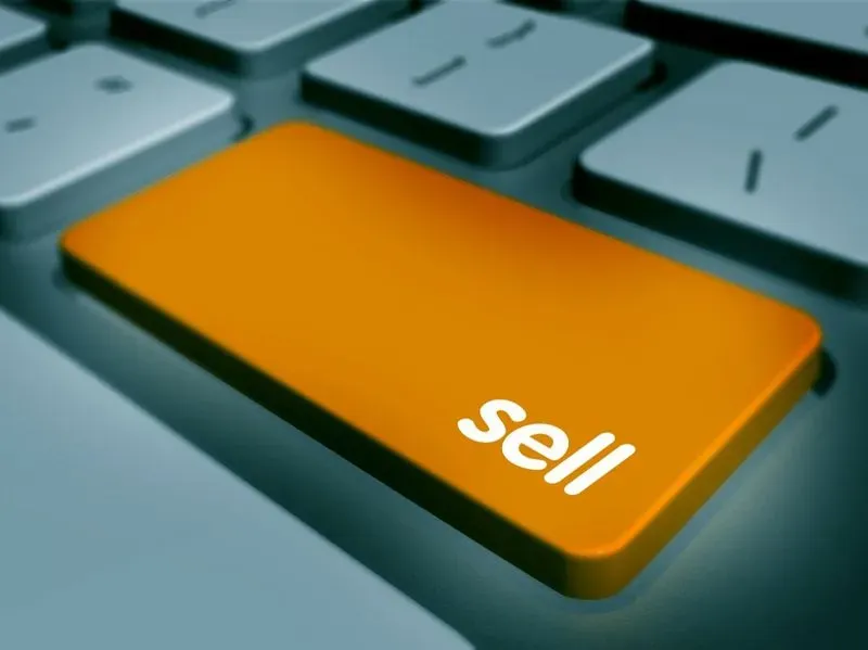 A computer keyboard with the word sell on it.