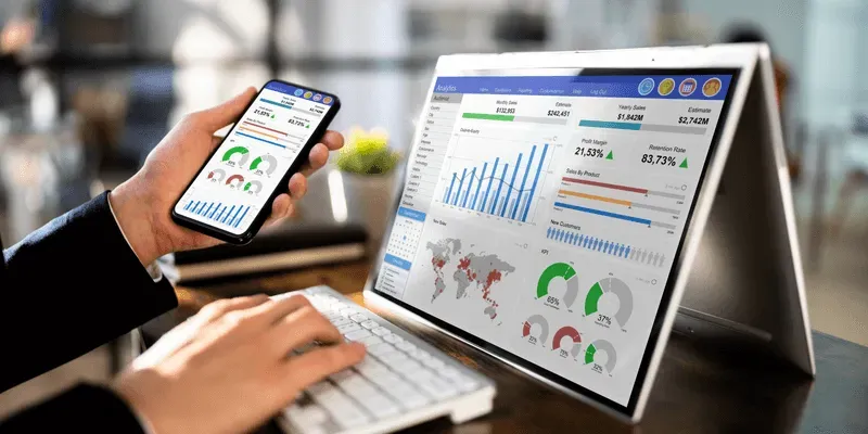 A person is using a laptop with a graph on it.