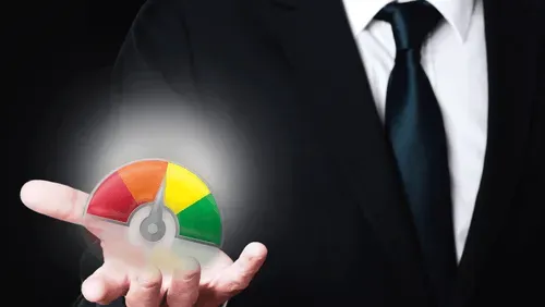 A businessman holding a gauge in his hand.