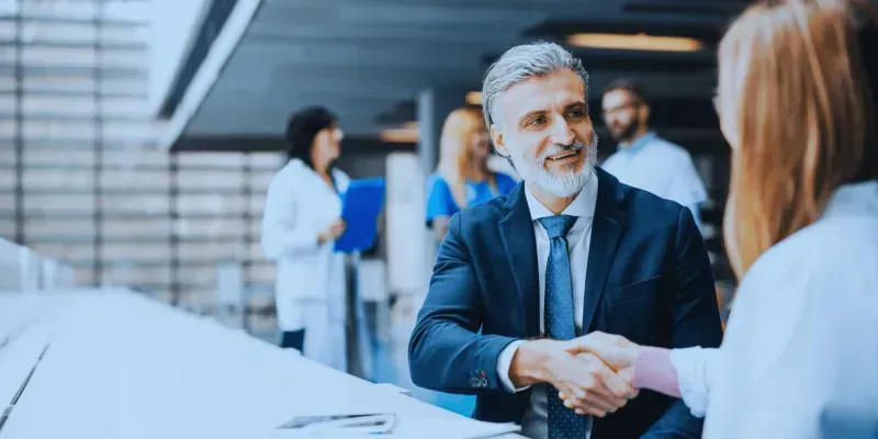 Buyer and seller shaking hands in a business deal.
