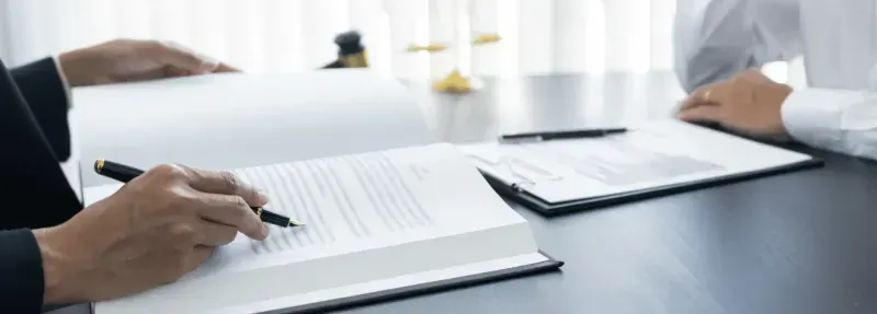 Professionals reviewing documents at the closing table.