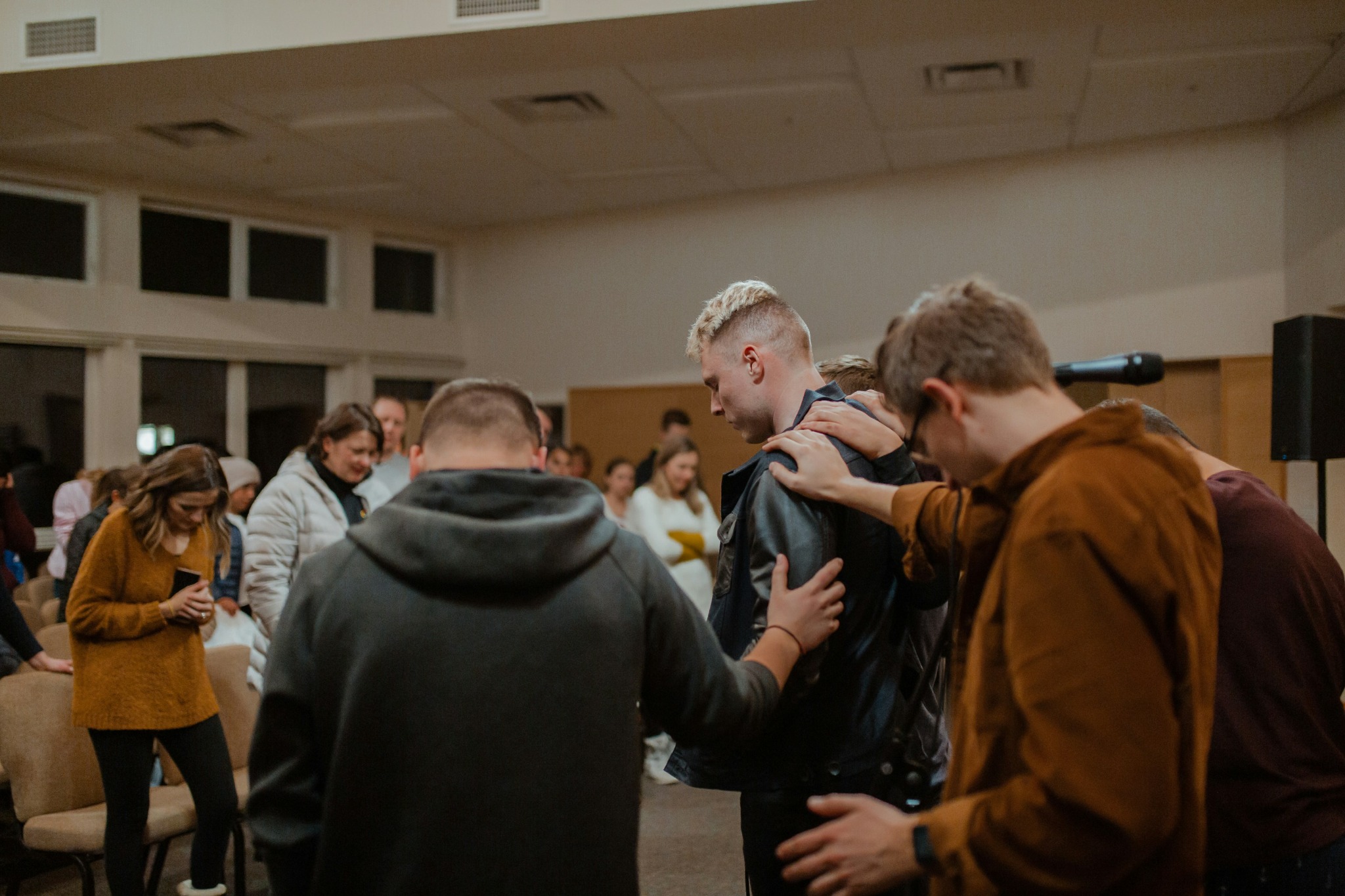 People praying together during a Lifted By Faith community gathering