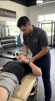 Patient working with a provider at a physical therapy clinic in Friendswood performing manual therapy treatment