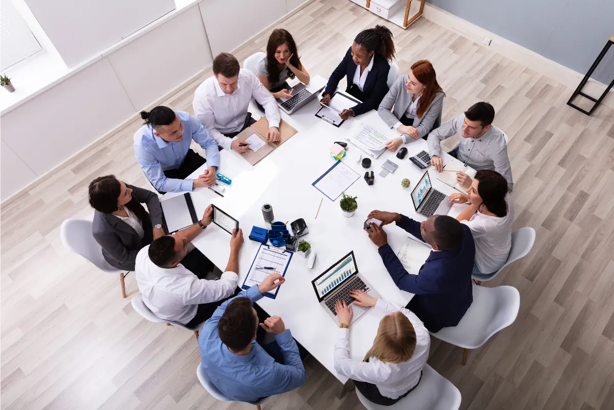 Overhead view of a business team meeting around a table