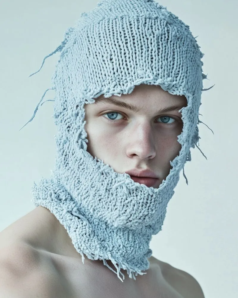 A man wearing a knitted hat and scarf.