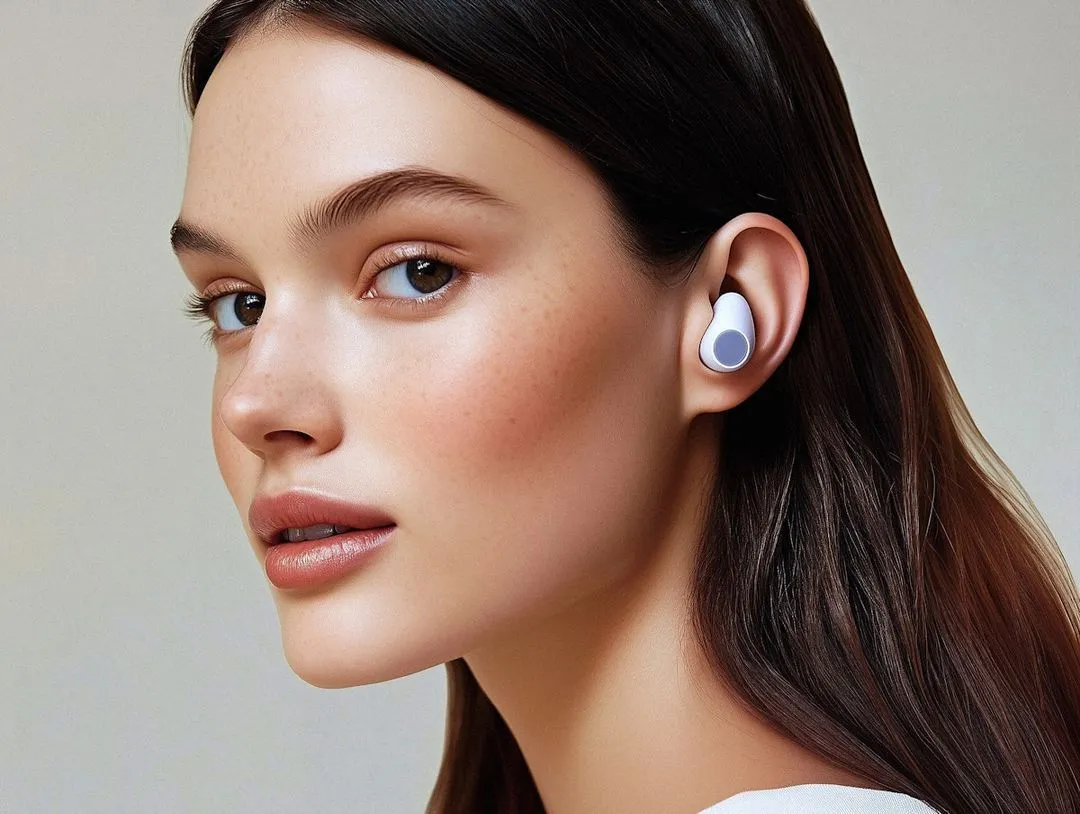 A woman wearing a pair of ear buds.