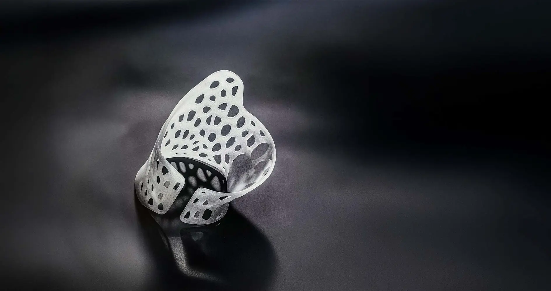 Three children smiling outdoors wearing back braces and standing close together in a park.