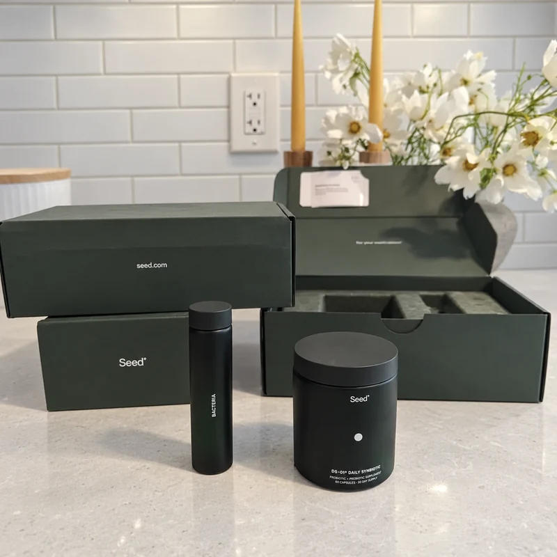 Seed DS-01 jar and travel vial on a light quartz kitchen counter