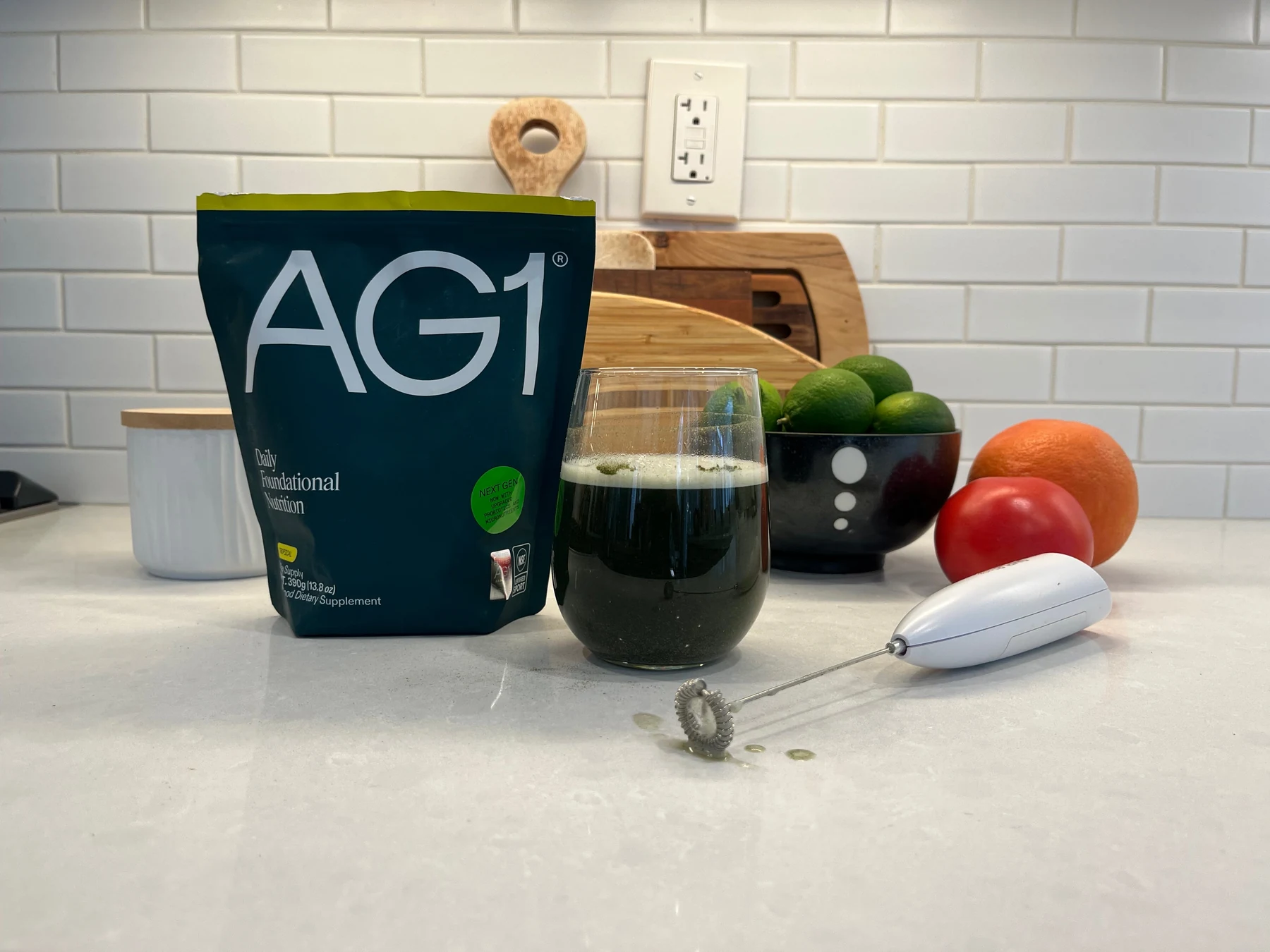 AG1 pouch and prepared drink on a light quartz kitchen counter