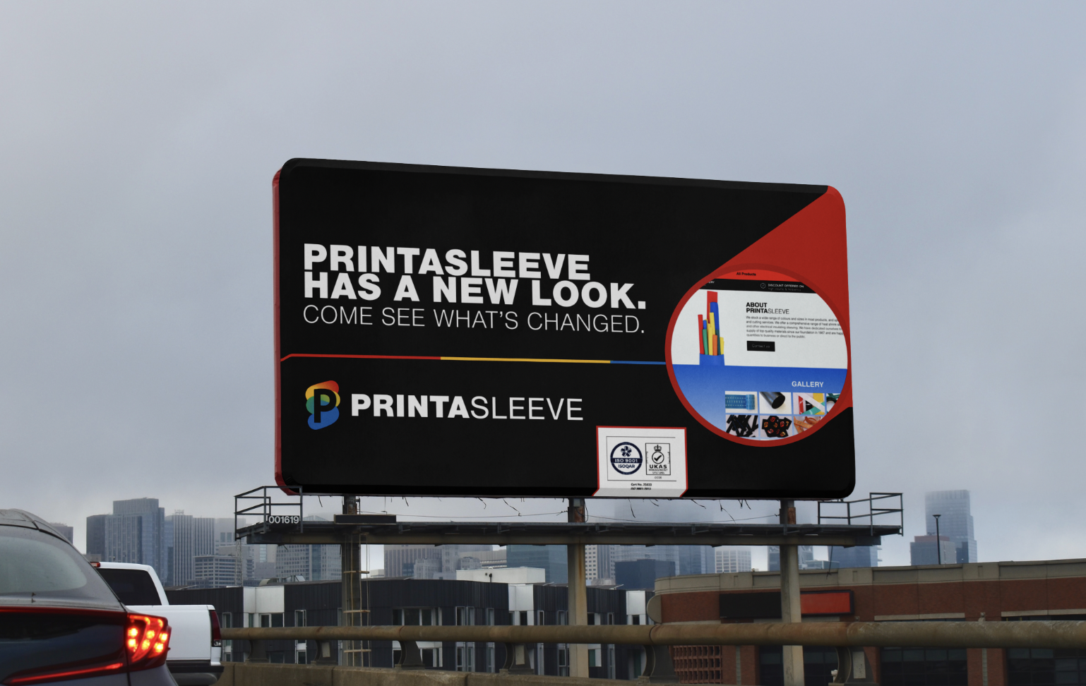 Billboard over city buildings with text 'Printasleeve has a new look. Come see what's changed.' and Printasleeve logo.