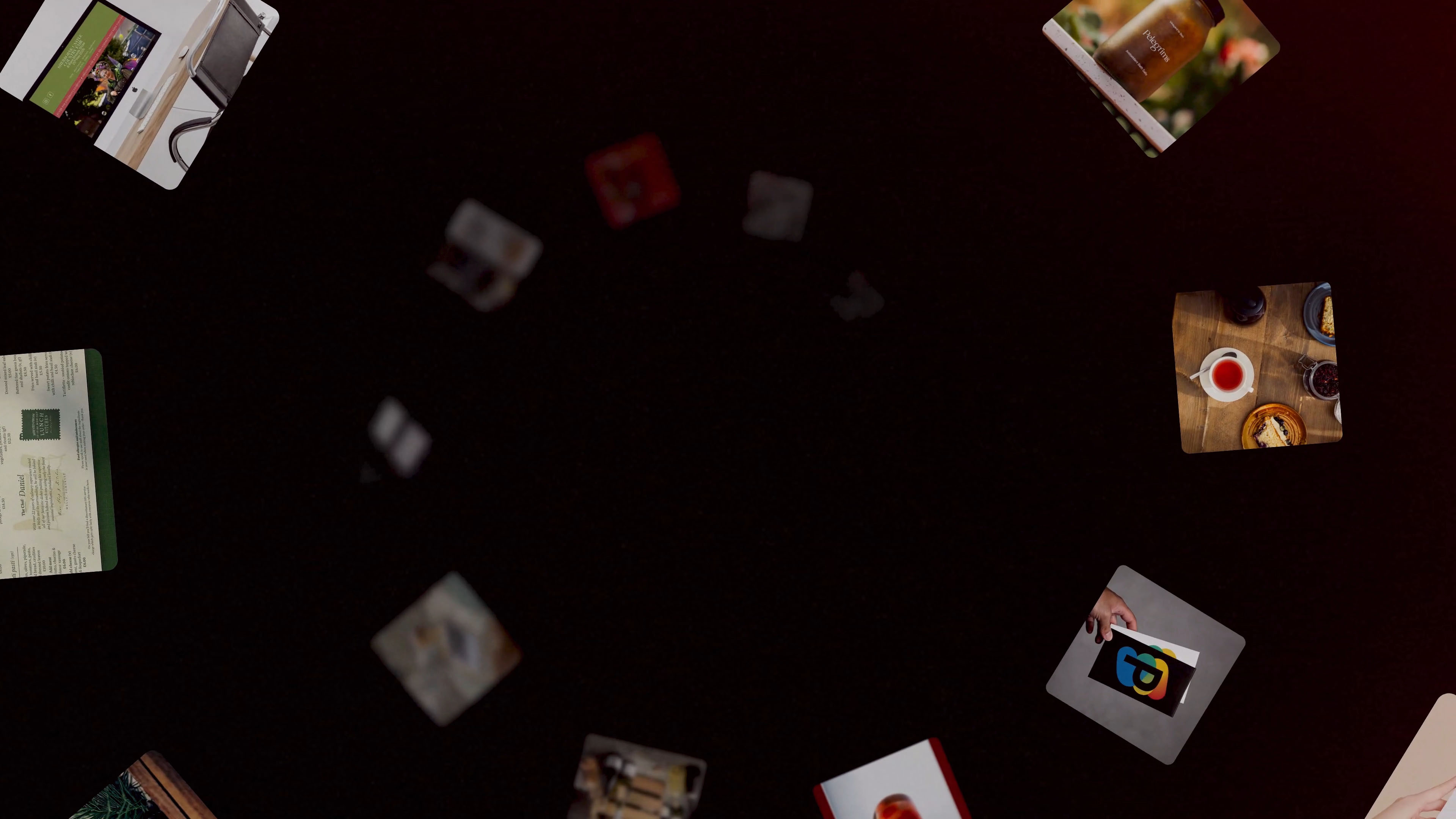 Dark background with scattered small floating images including a cup of tea and cake, a brown jar, and a hand holding a card with a colorful overlapping shapes logo.