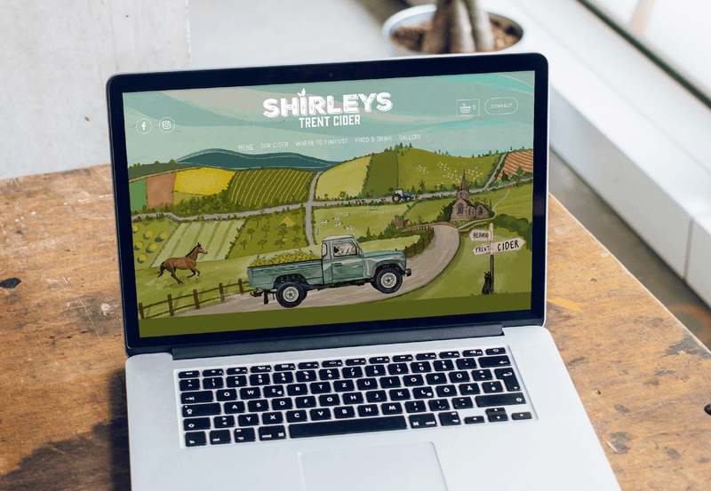 Shirley’s Cider website with illustrated Dorset scenery on a laptop.