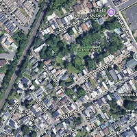 Aerial map view showing a dense urban area with the Sanboku Museum and the ER Memorial surrounded by trees and streets.