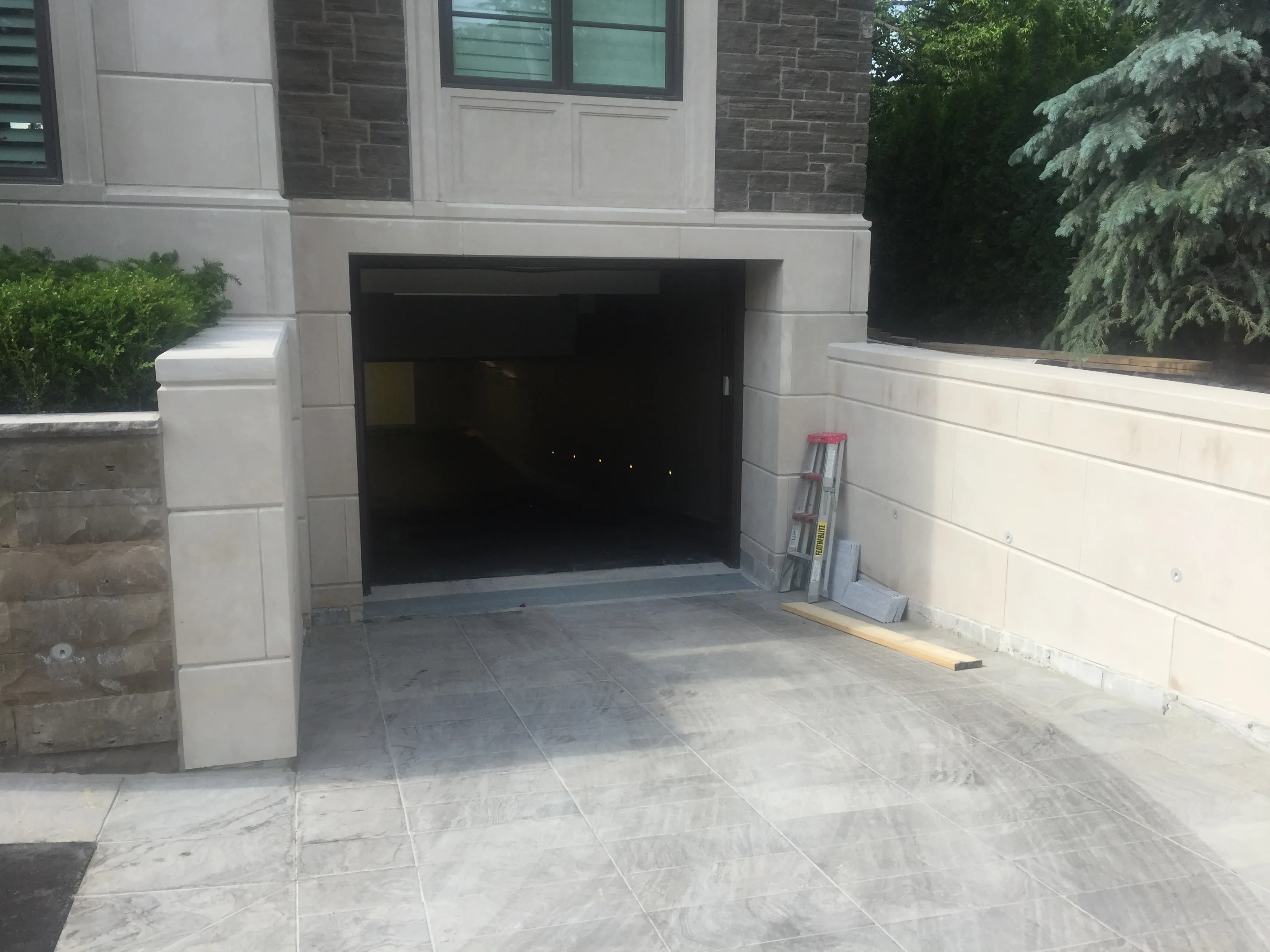 Finished concrete driveway leading to an underground garage
