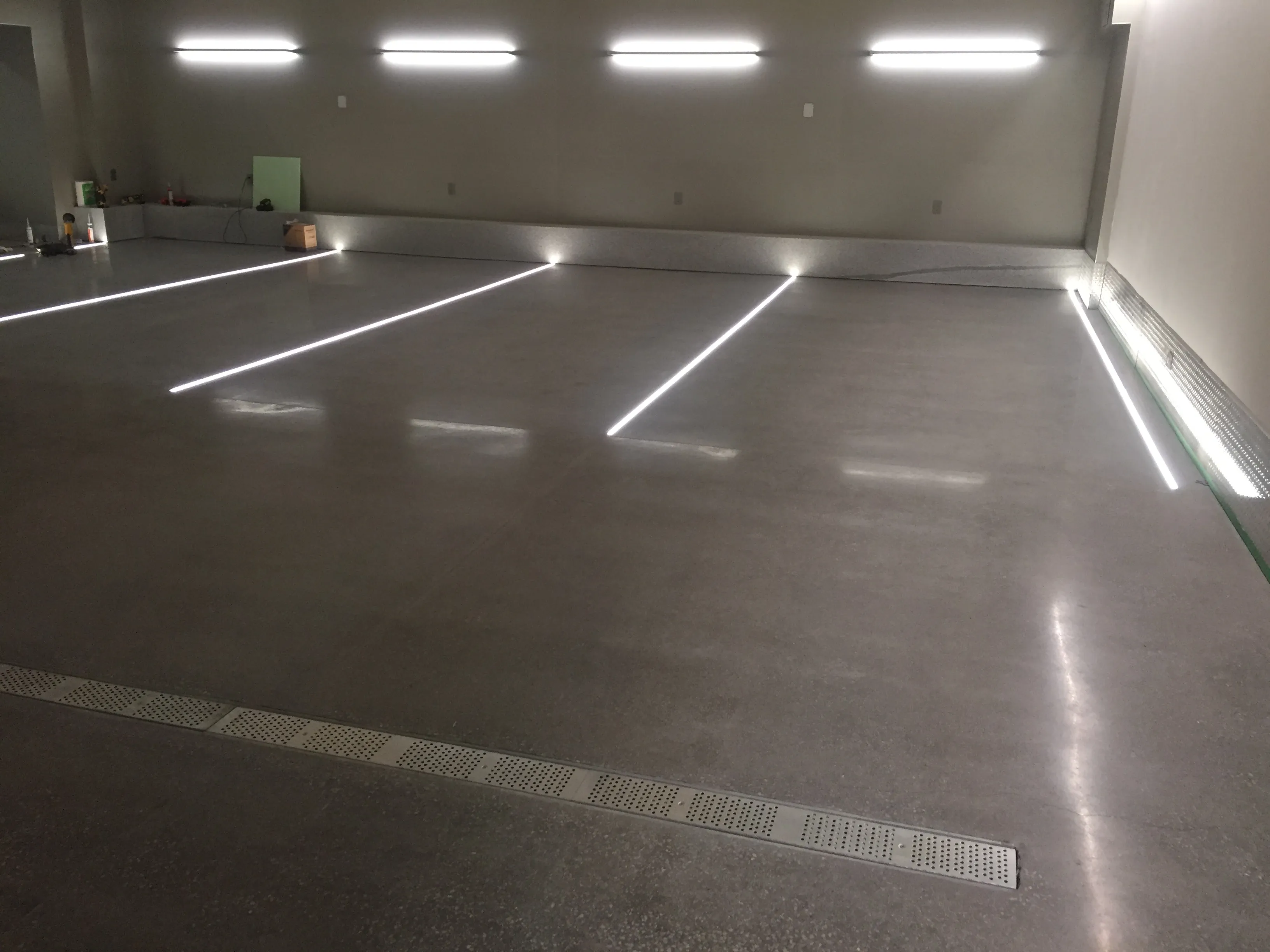 Polished concrete garage floor with trench drain and LED lighting