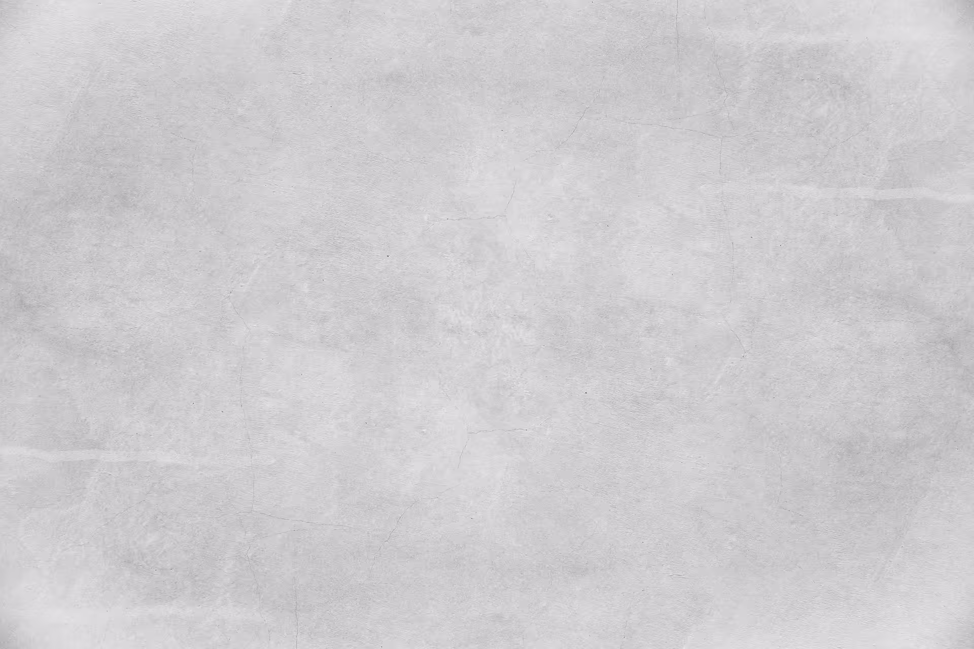 Light grey concrete wall with subtle texture and faint cracks.