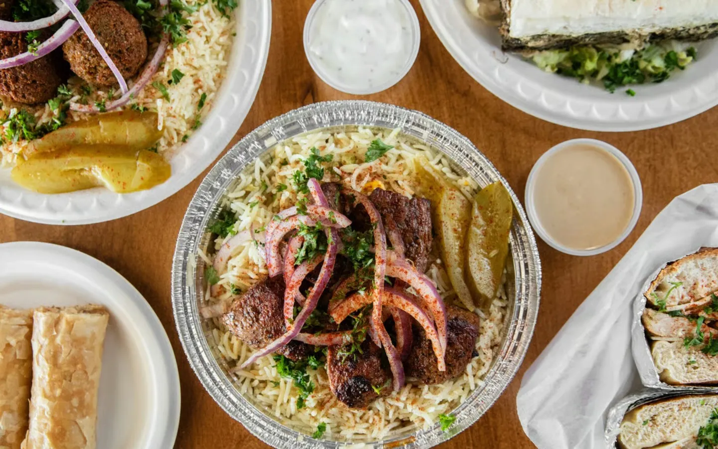 A plate of food with rice, meat, and vegetables.