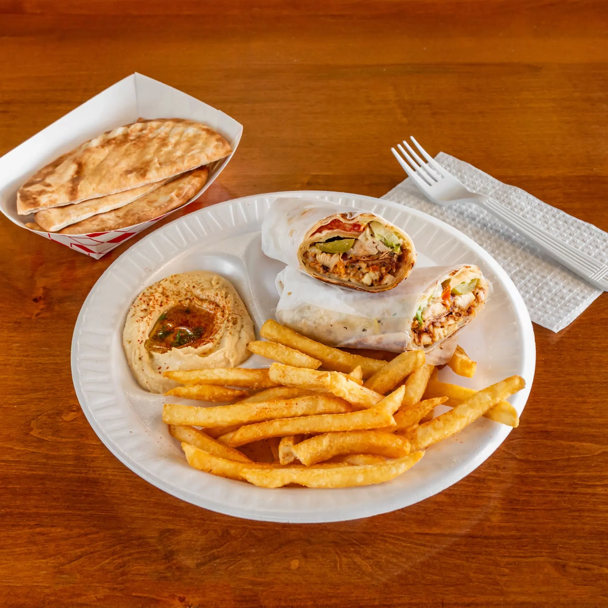 A plate of food with a fork and a napkin.