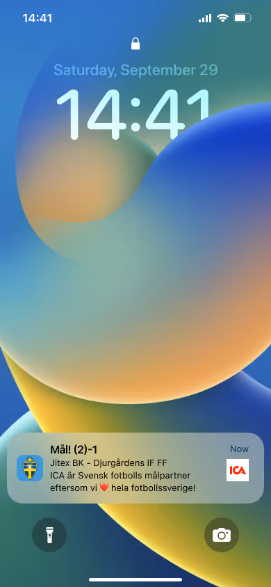 Smartphone lock screen showing time 14:41 on Saturday, September 29, with a notification about a football score from Jitex BK vs Djurgårdens IF FF and a message about ICA being a Swedish football partner.