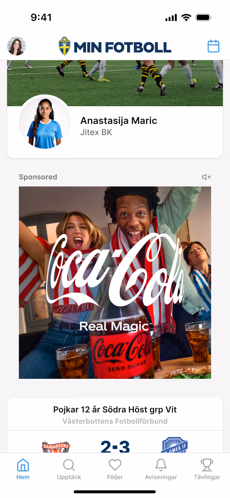 Three excited people wearing red and white or blue and white scarves cheering with glasses of Coca-Cola Zero Sugar on a table.