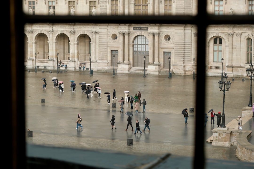 a group of people walking around a courtyard