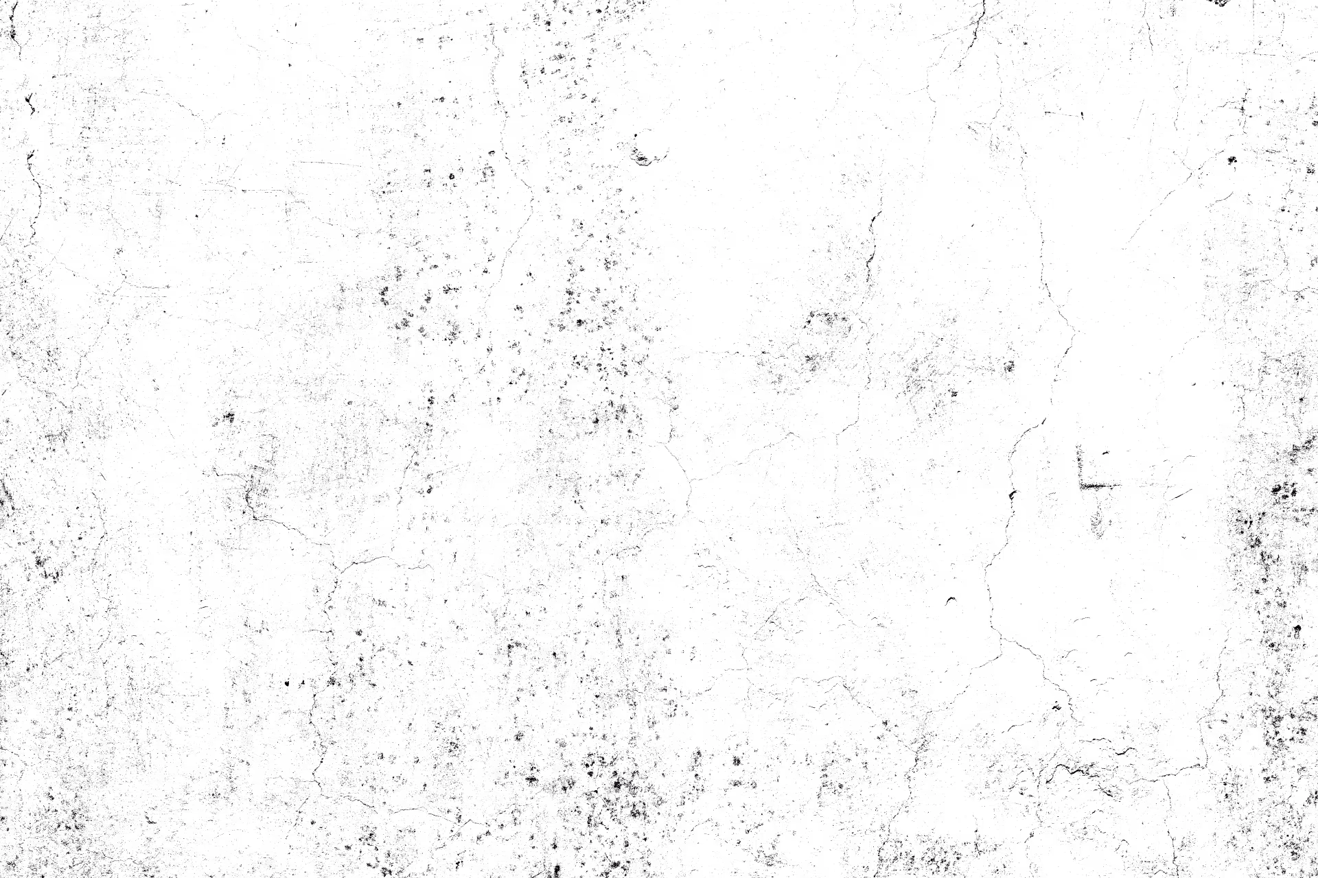 Weathered white concrete wall with distressed surface, cracks, and black speckles.