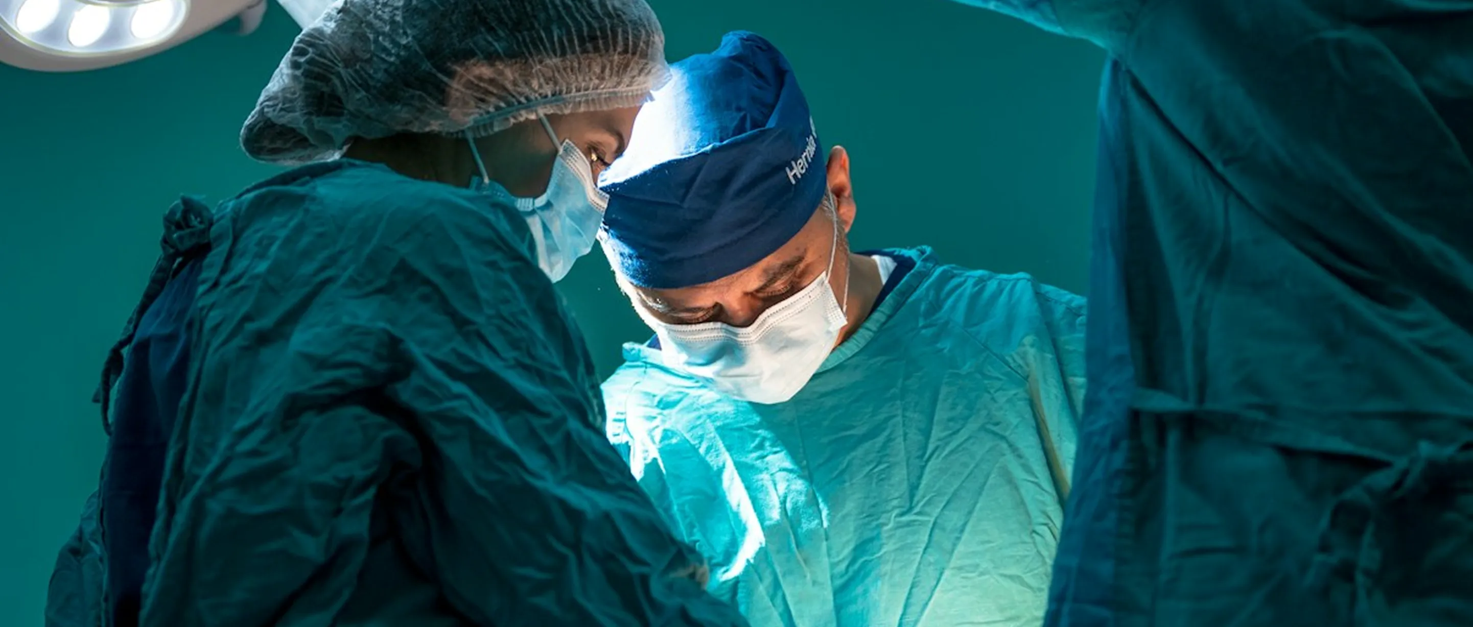 Surgeons in the operating room, aqua green environment 