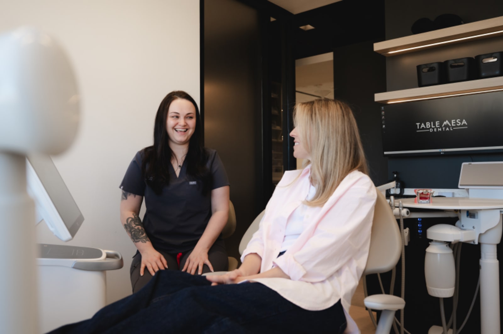 Dentist discussing treatment plan with female patient in dental office consultation