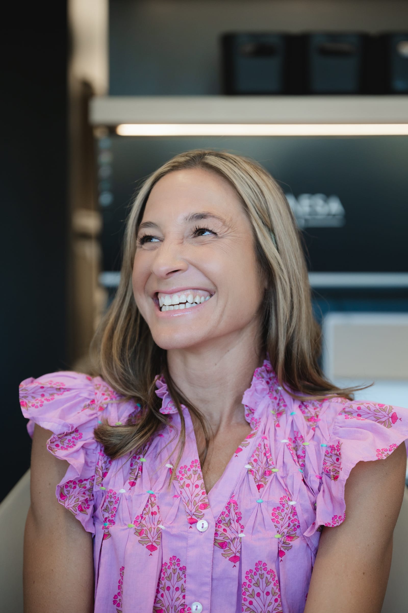 Smiling female team member in dental practice uniform