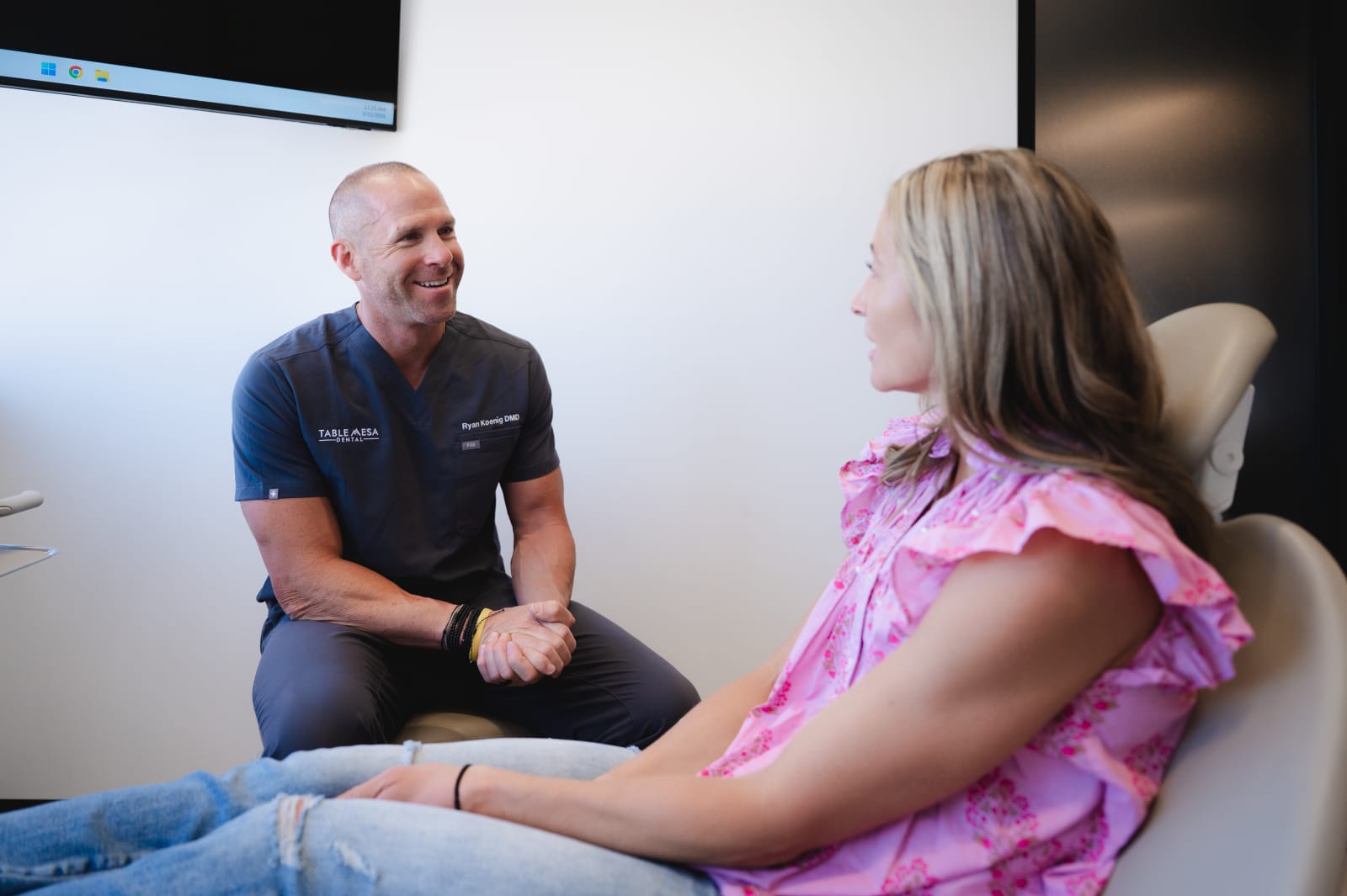Dentist conducting patient consultation and examination during TMJ assessment