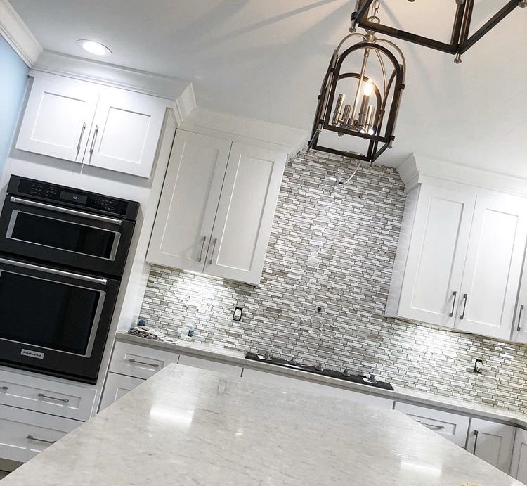 Refined kitchen backsplash with clean tile lines and warm cabinetry