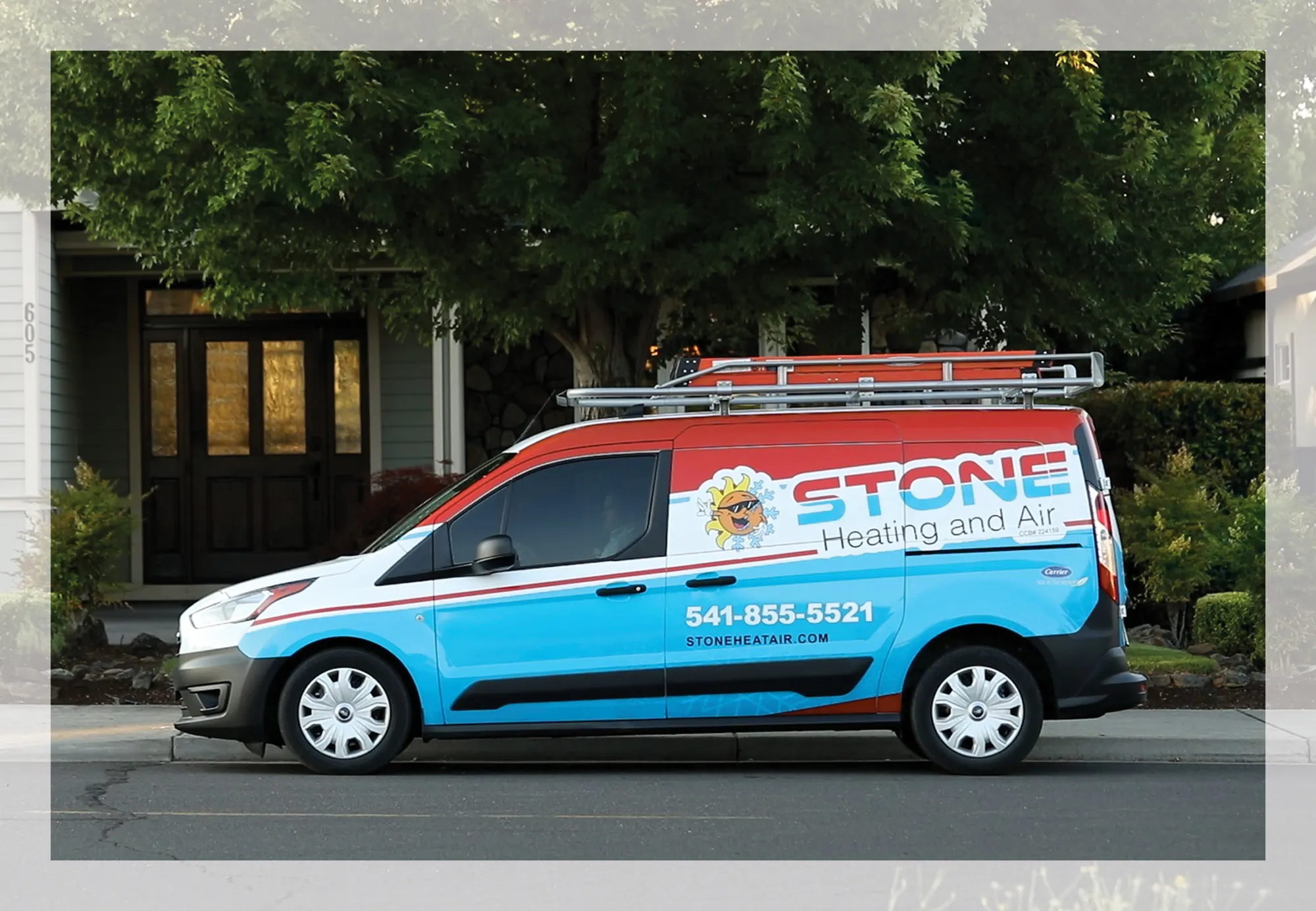 Blue and red Stone Heating and Air service van parked on a residential street with phone number and website displayed.