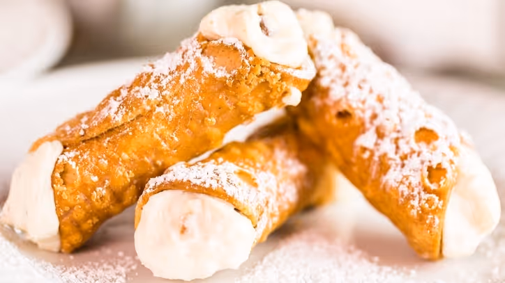 Fresh cannolis filled with ricotta cheese